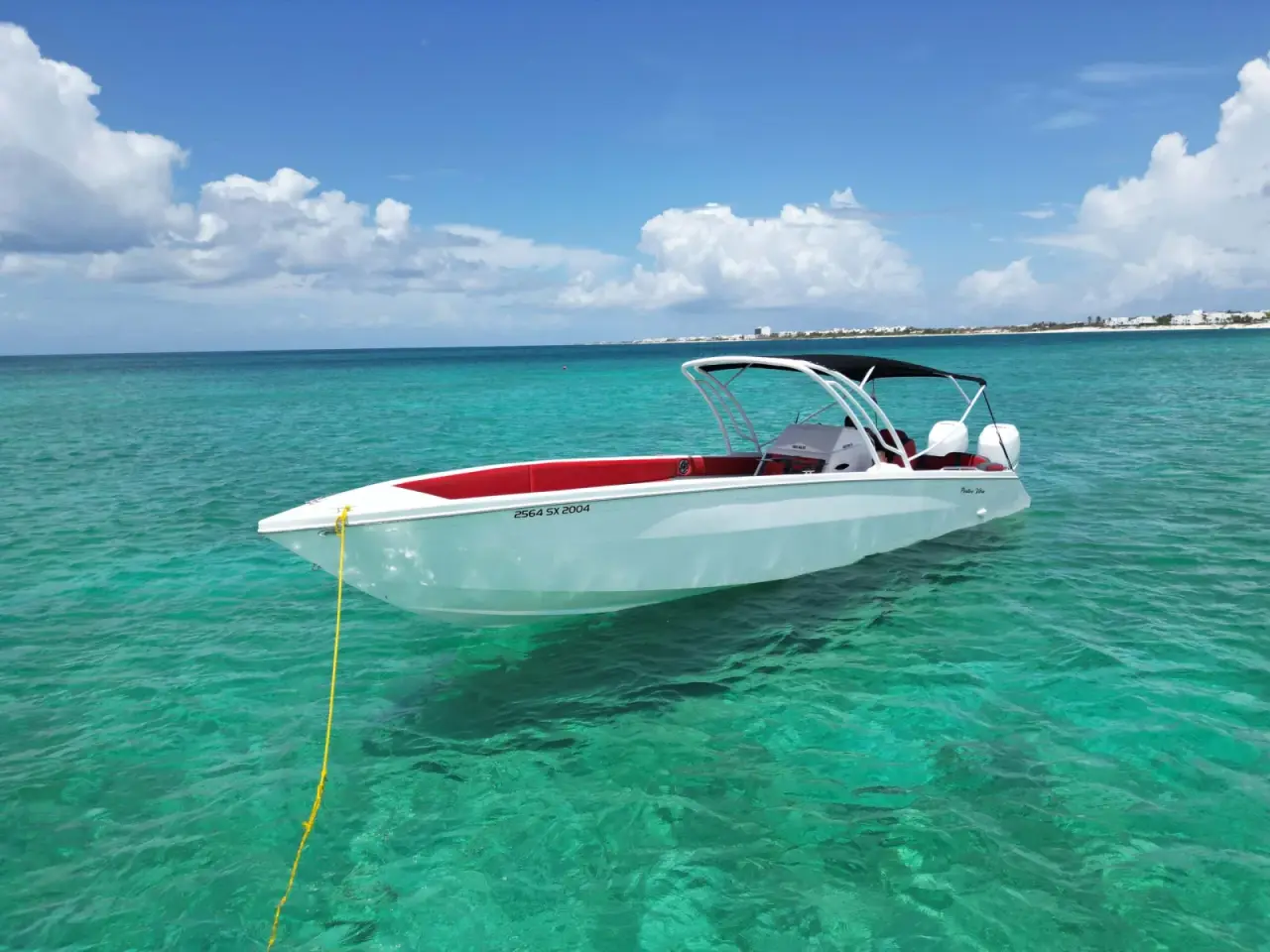 Cigarette 36 Positive Vibes at anchor in turquoise water